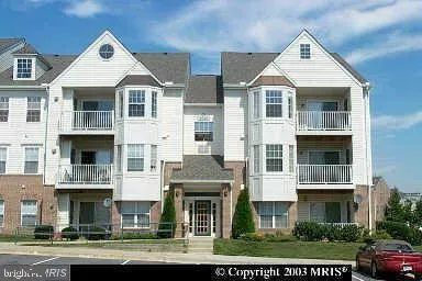 a front view of a residential apartment building with a yard