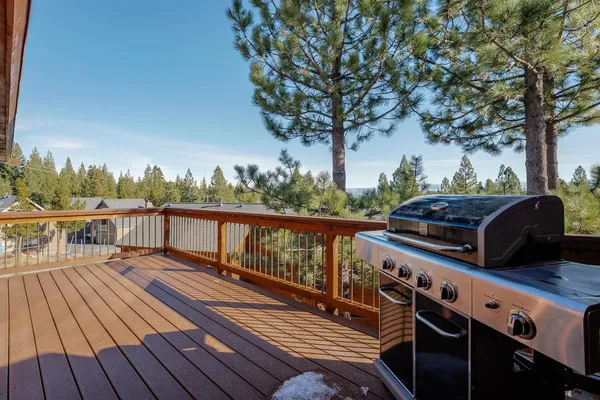 a view of a balcony with wooden floor and outdoor seating