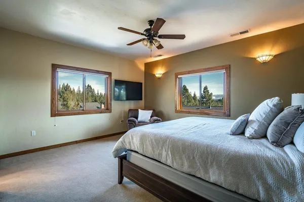 a bedroom with a large bed and a chandelier