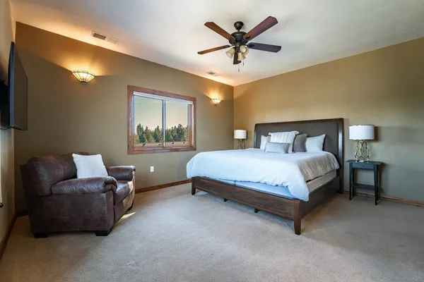 a bedroom with a bed a couch and window