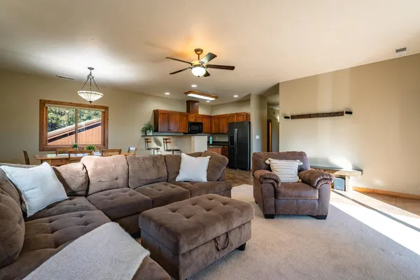 a living room with furniture ceiling fan and a rug
