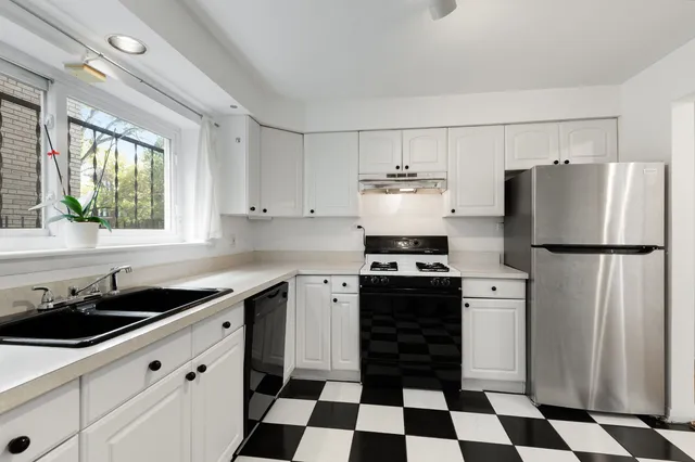 a kitchen with a refrigerator a sink and a stove