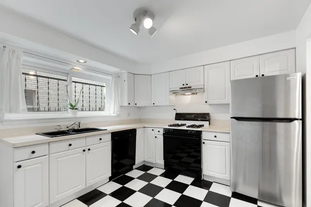 a kitchen with a white stove top oven and refrigerator