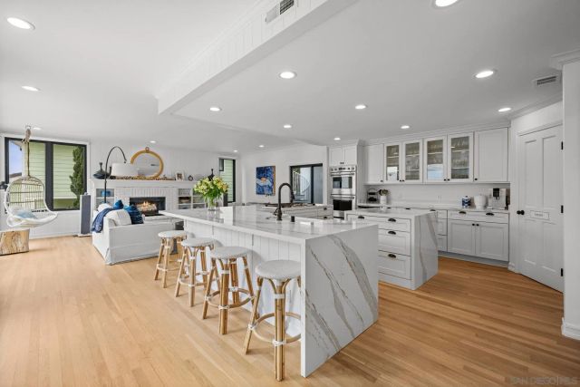 a view of a kitchen with cabinets and wooden floor