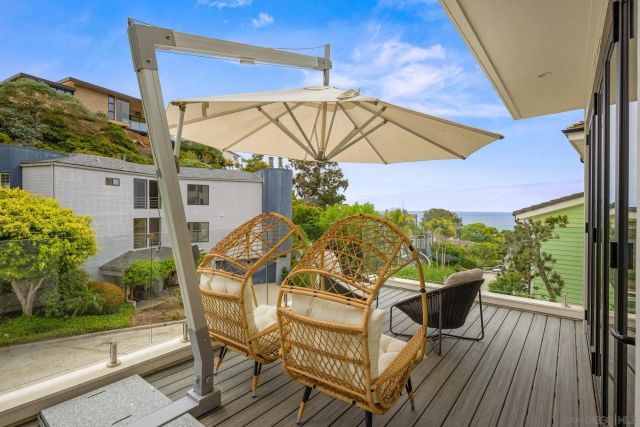 a view of a chairs and table in the balcony