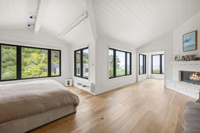 a spacious bedroom with a large bed and a large window