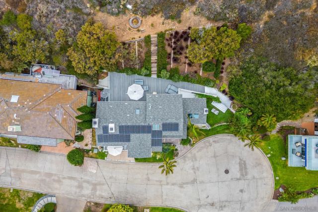 an aerial view of a house with yard and green space