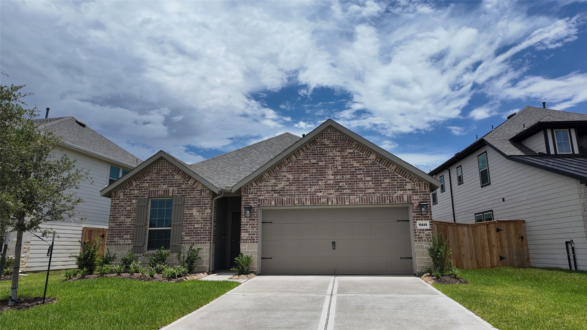 15645 Wandering Maple Way Conroe, TX 77302 - Photo 1 of 14 front view of a house with a yard