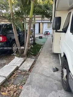 a view of a backyard with furniture and a flat screen tv