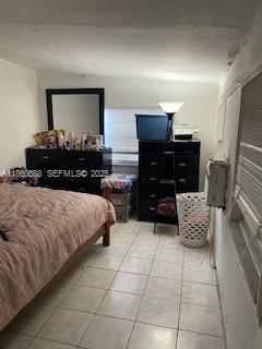 6034 Fillmore Street Hollywood, FL 33024 - Photo 10 of 13 a bedroom with a bed and a mirror