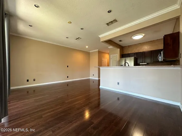 a view of a kitchen with a sink and a refrigerator