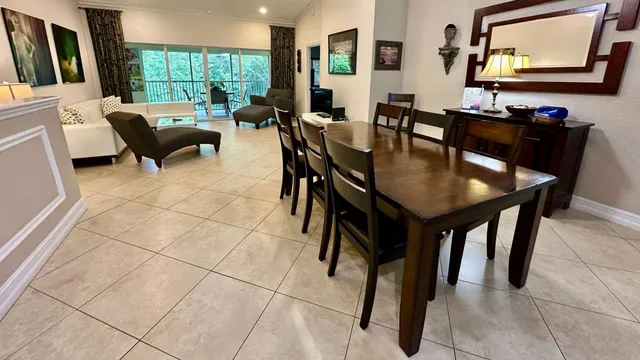 a view of a bathroom with tub shower and mirror