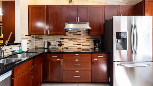 a bedroom with a bed and a flat tv screen on dresser