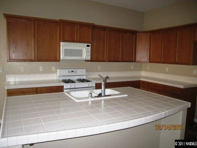 2495 Baton Drive Reno, NV 89521 - Photo 3 of 13 a kitchen with a sink and cabinets