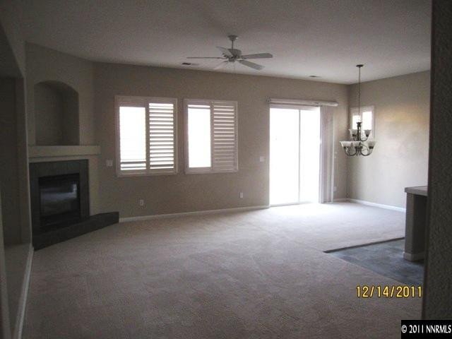 2495 Baton Drive Reno, NV 89521 - Photo 4 of 13 an empty room with windows and fireplace