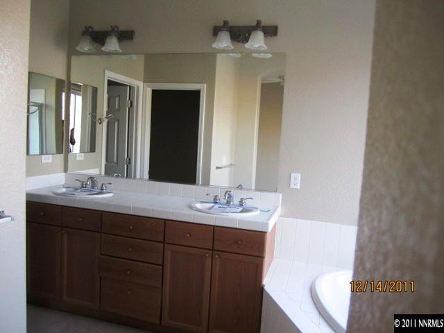 2495 Baton Drive Reno, NV 89521 - Photo 8 of 13 a bathroom with a granite countertop sink mirror and toilet