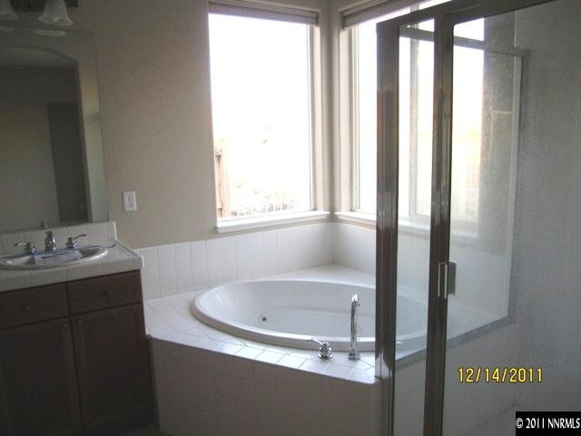 2495 Baton Drive Reno, NV 89521 - Photo 10 of 13 a bathroom with a granite countertop sink and a bathtub