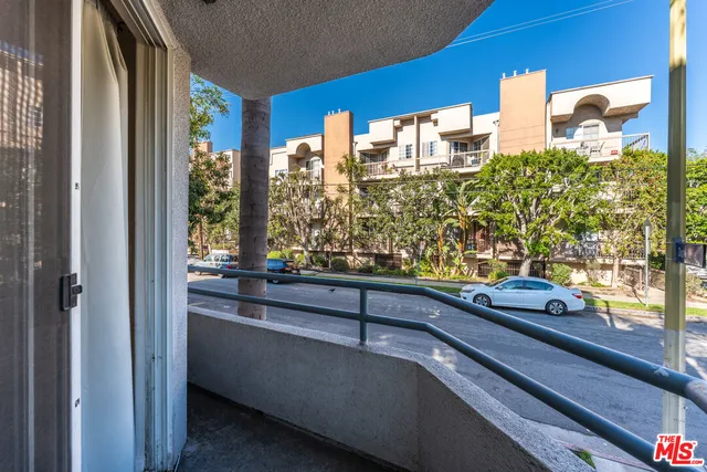 a view of balcony with a yard