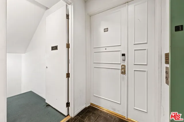 a view of a livingroom with wooden floor and a fireplace