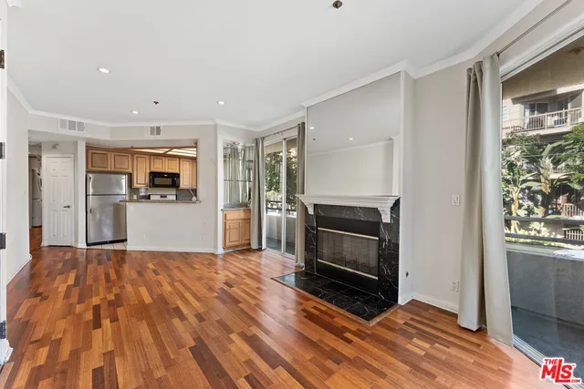 a big room with wooden floor and windows