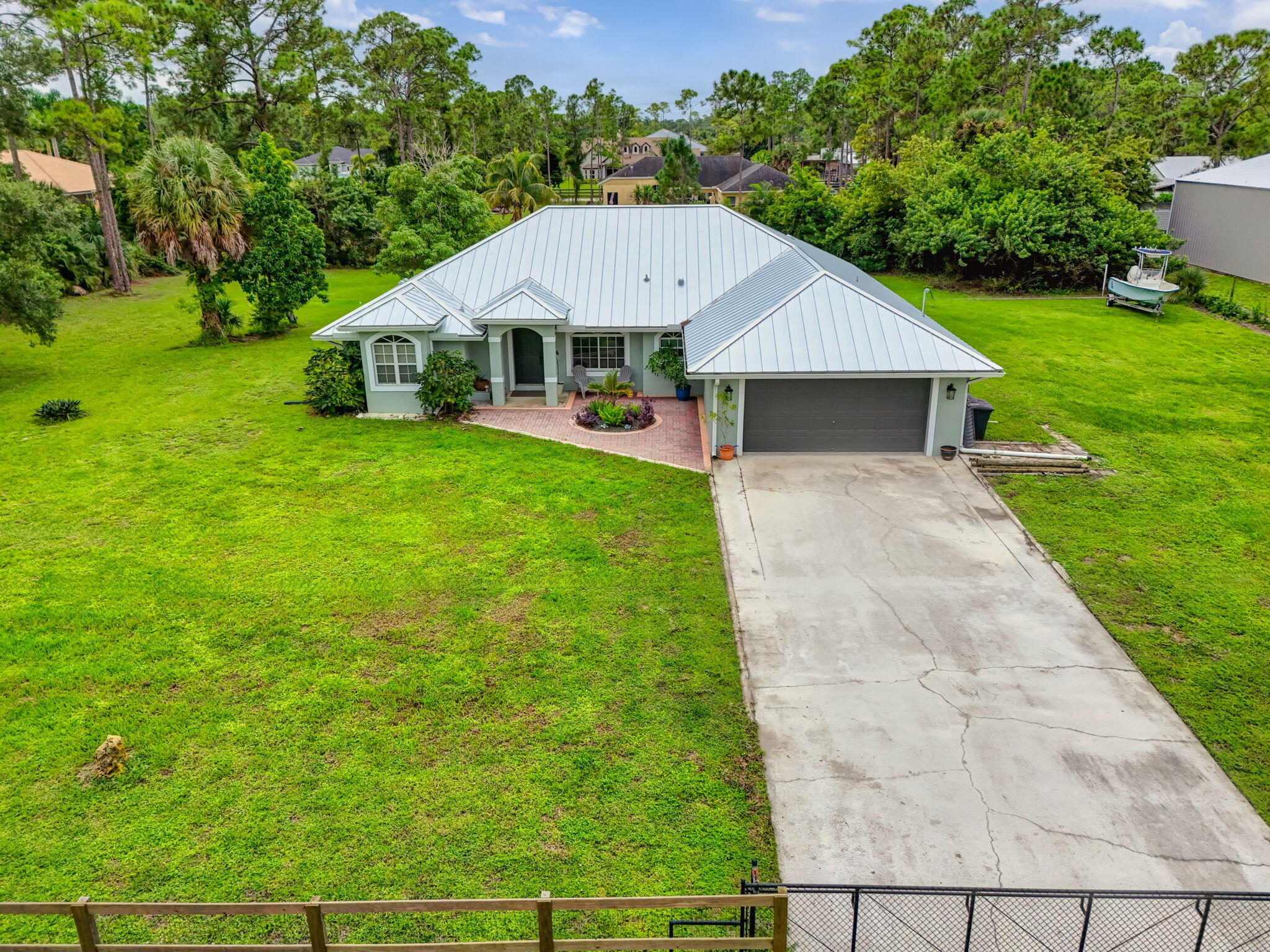 14366 76th Road North The Acreage, FL 33470 - Photo 2 of 76 a aerial view of a yard in front of house