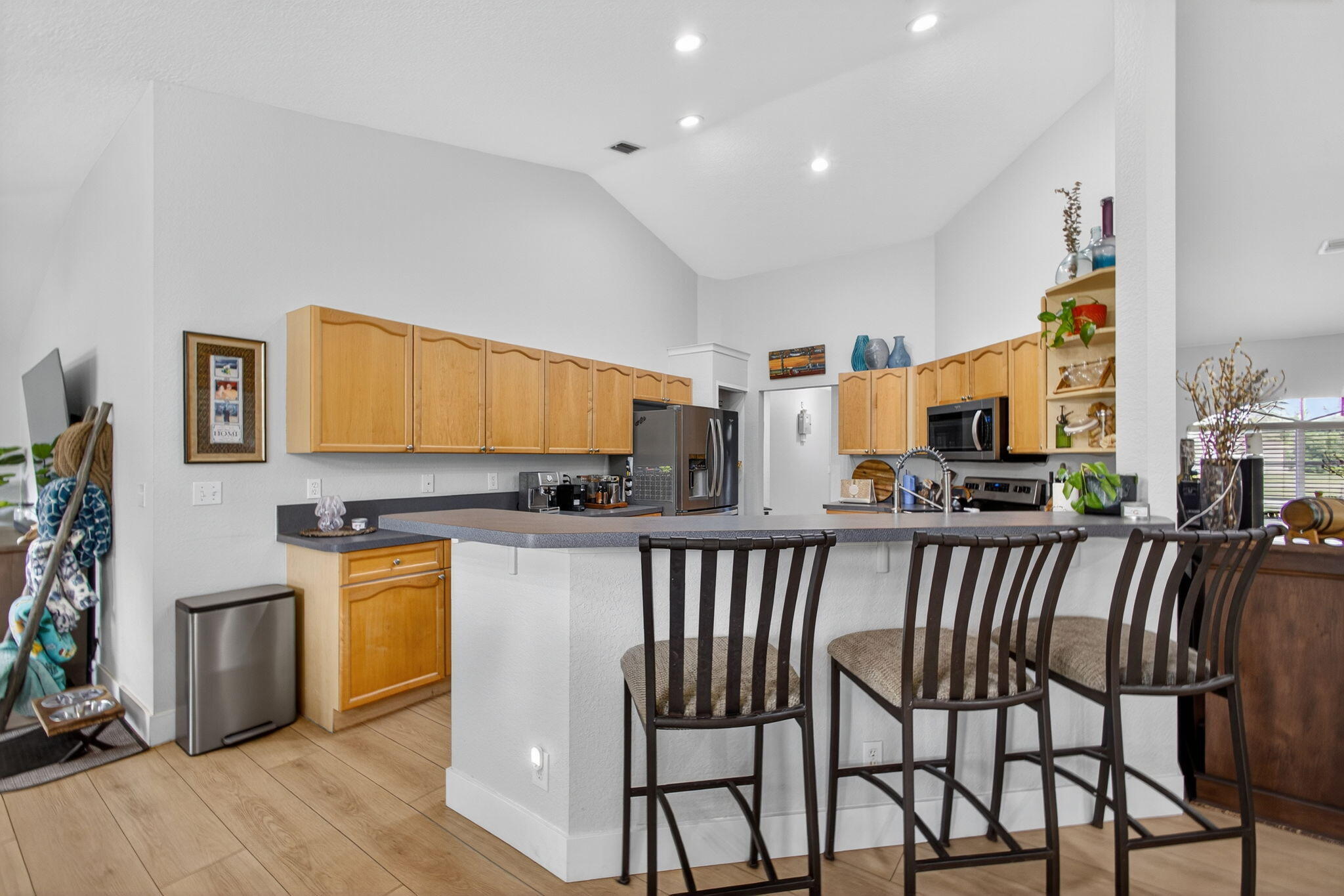 14366 76th Road North The Acreage, FL 33470 - Photo 22 of 76 a kitchen with a table chairs microwave and cabinets