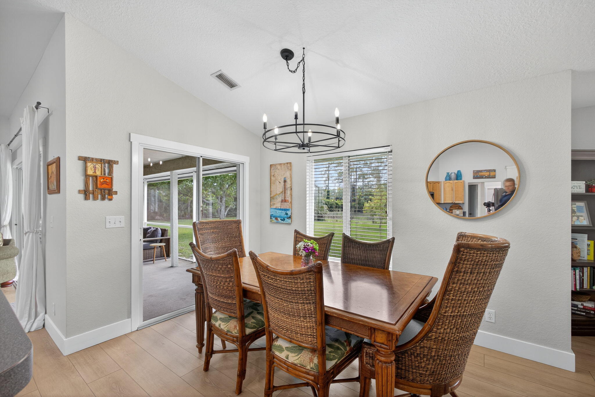 14366 76th Road North The Acreage, FL 33470 - Photo 27 of 76 a dining room with furniture a chandelier and wooden floor