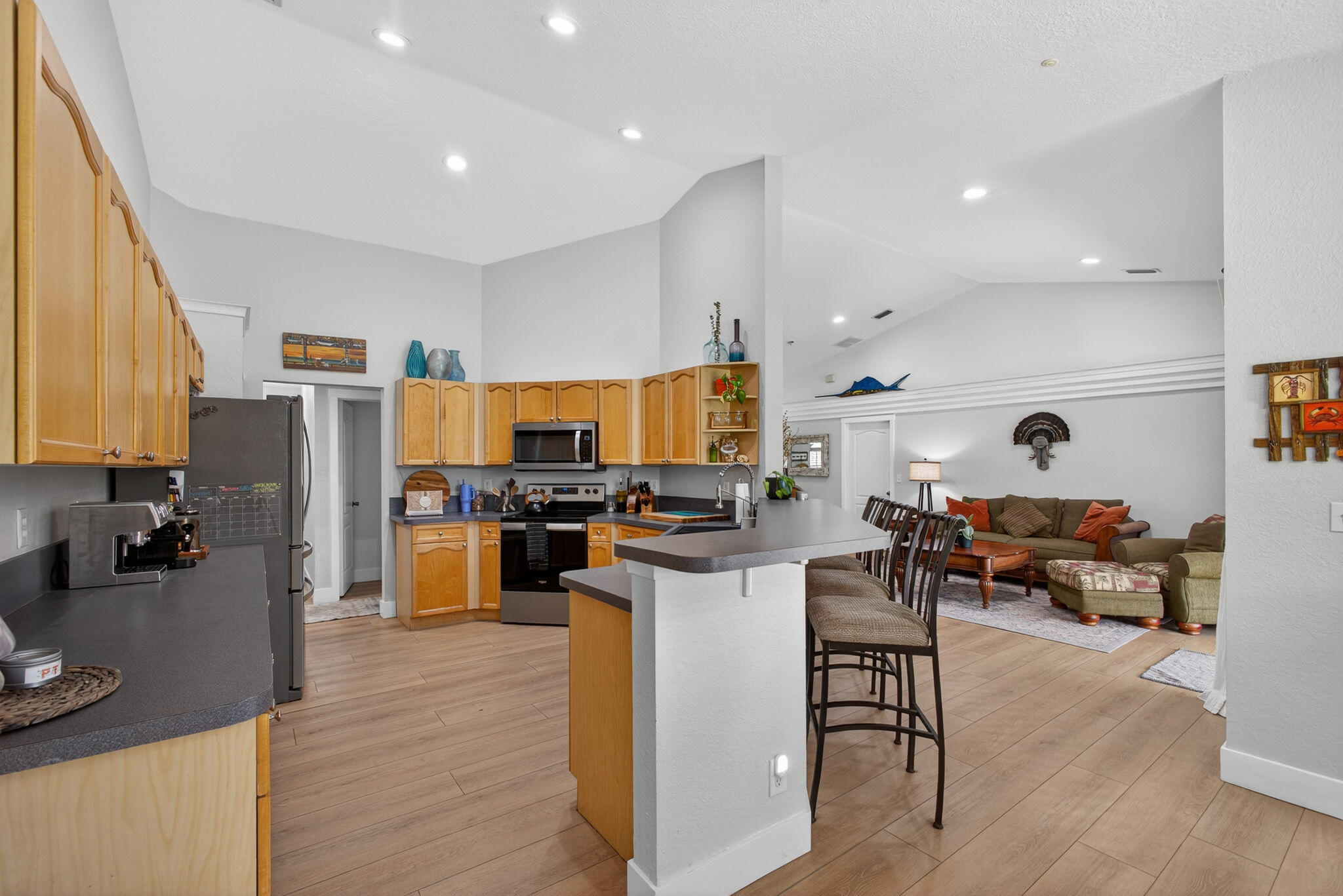 14366 76th Road North The Acreage, FL 33470 - Photo 31 of 76 a living room with stainless steel appliances furniture and a view of kitchen