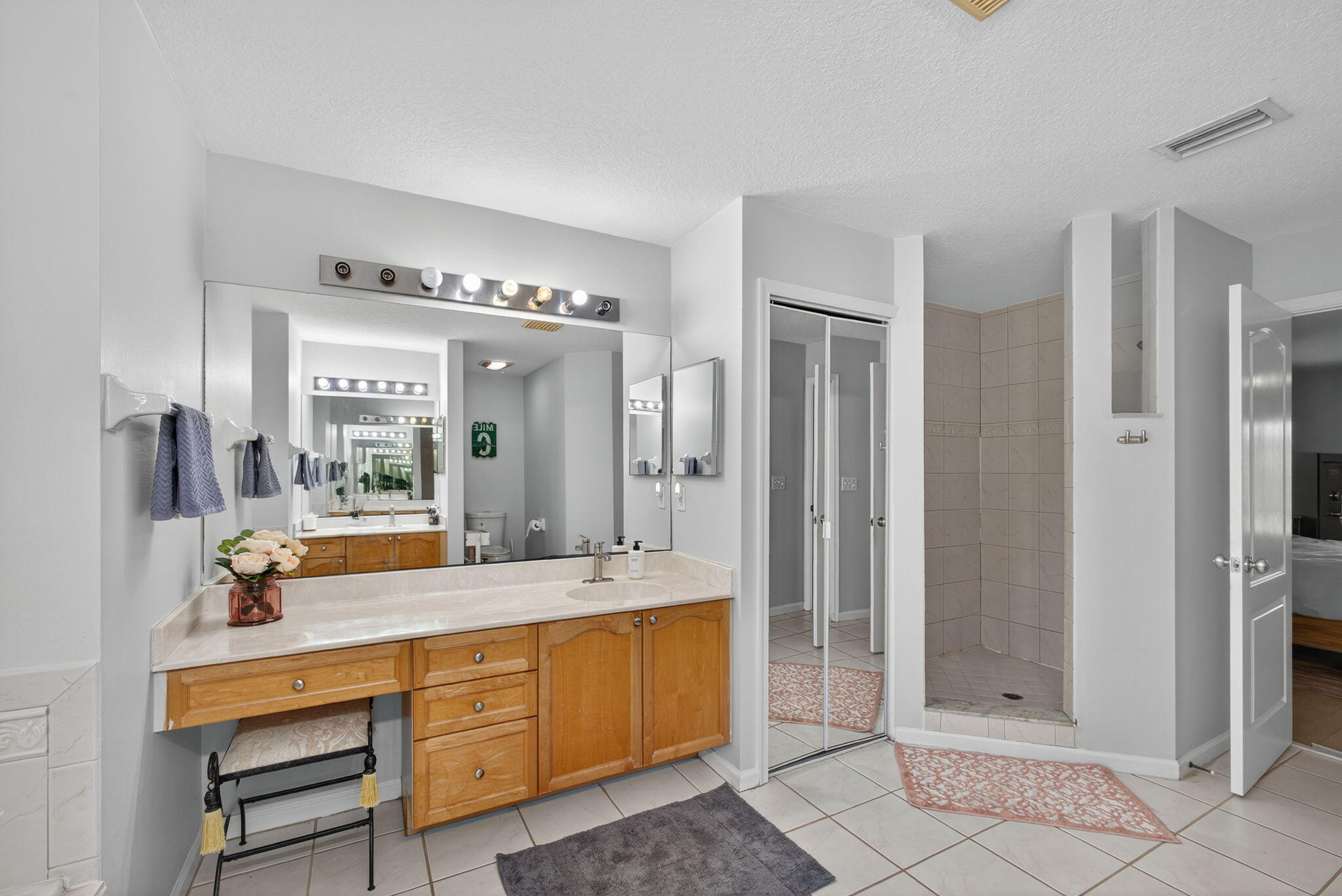 14366 76th Road North The Acreage, FL 33470 - Photo 47 of 76 a bathroom with a double vanity sink mirror and shower