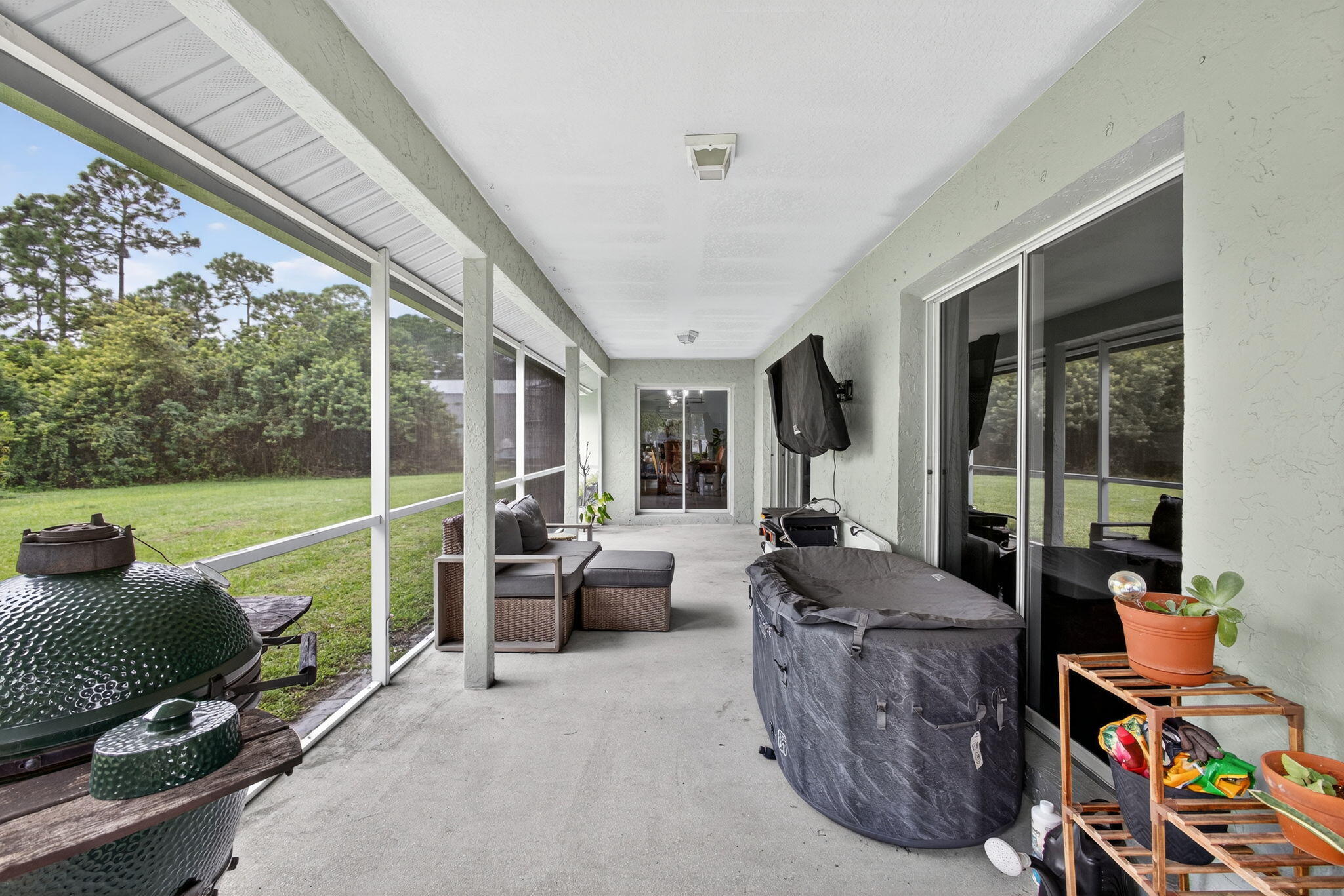 14366 76th Road North The Acreage, FL 33470 - Photo 50 of 76 a living room with patio furniture and a floor to ceiling window