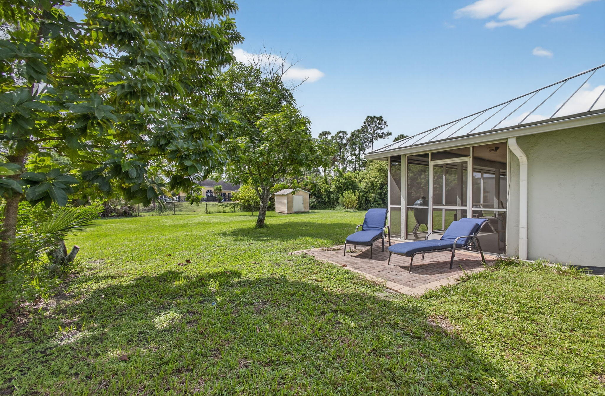 14366 76th Road North The Acreage, FL 33470 - Photo 59 of 76 a view of a house with backyard and sitting area