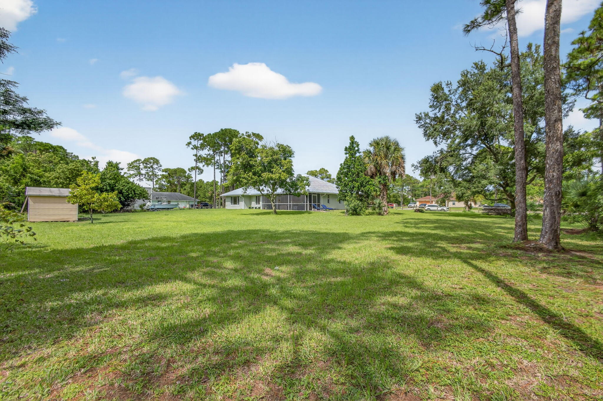 14366 76th Road North The Acreage, FL 33470 - Photo 61 of 76 a backyard of a house with lots of green space