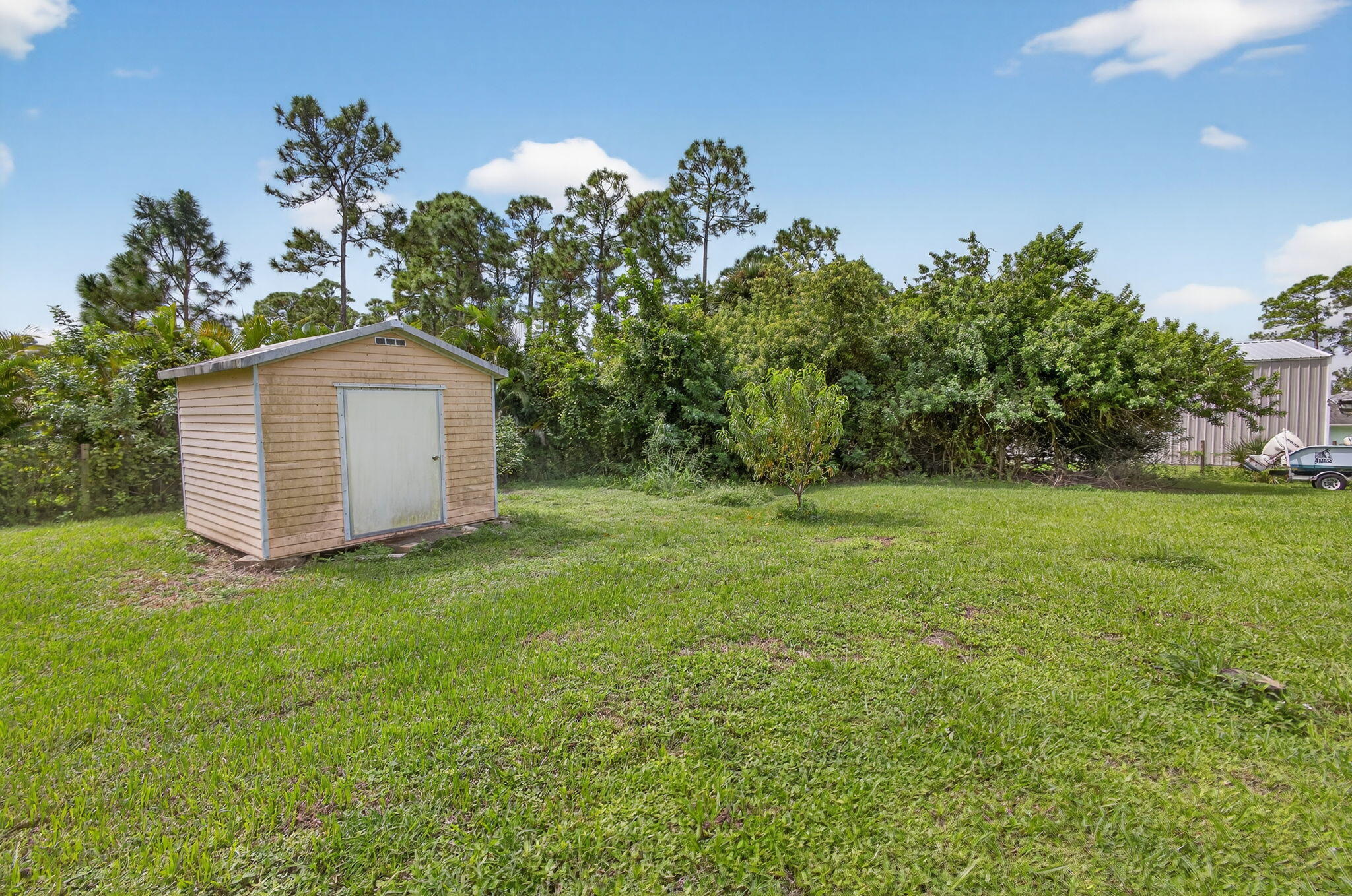 14366 76th Road North The Acreage, FL 33470 - Photo 63 of 76 a backyard of a house with lots of green space