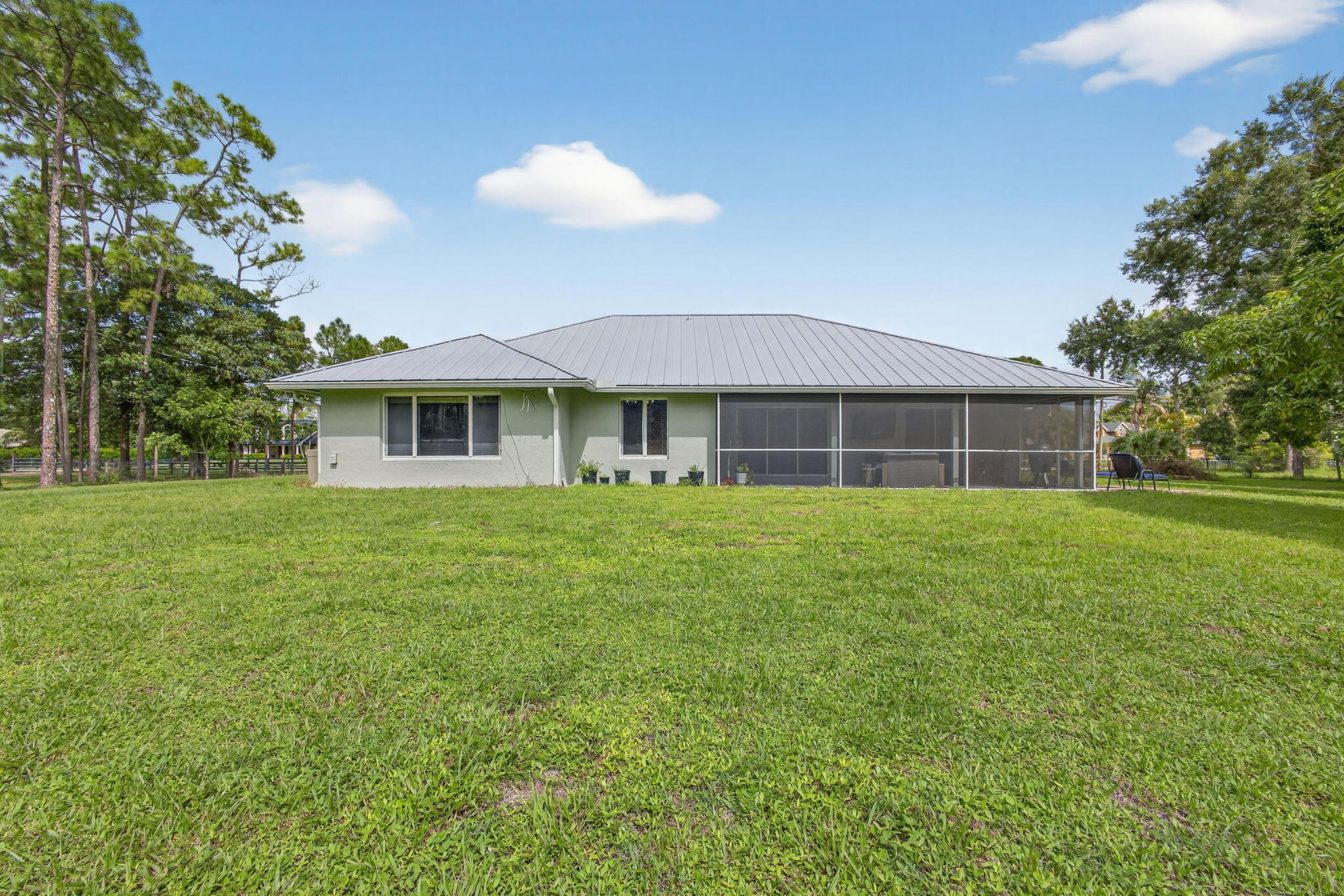 14366 76th Road North The Acreage, FL 33470 - Photo 64 of 76 a front view of a house with a garden