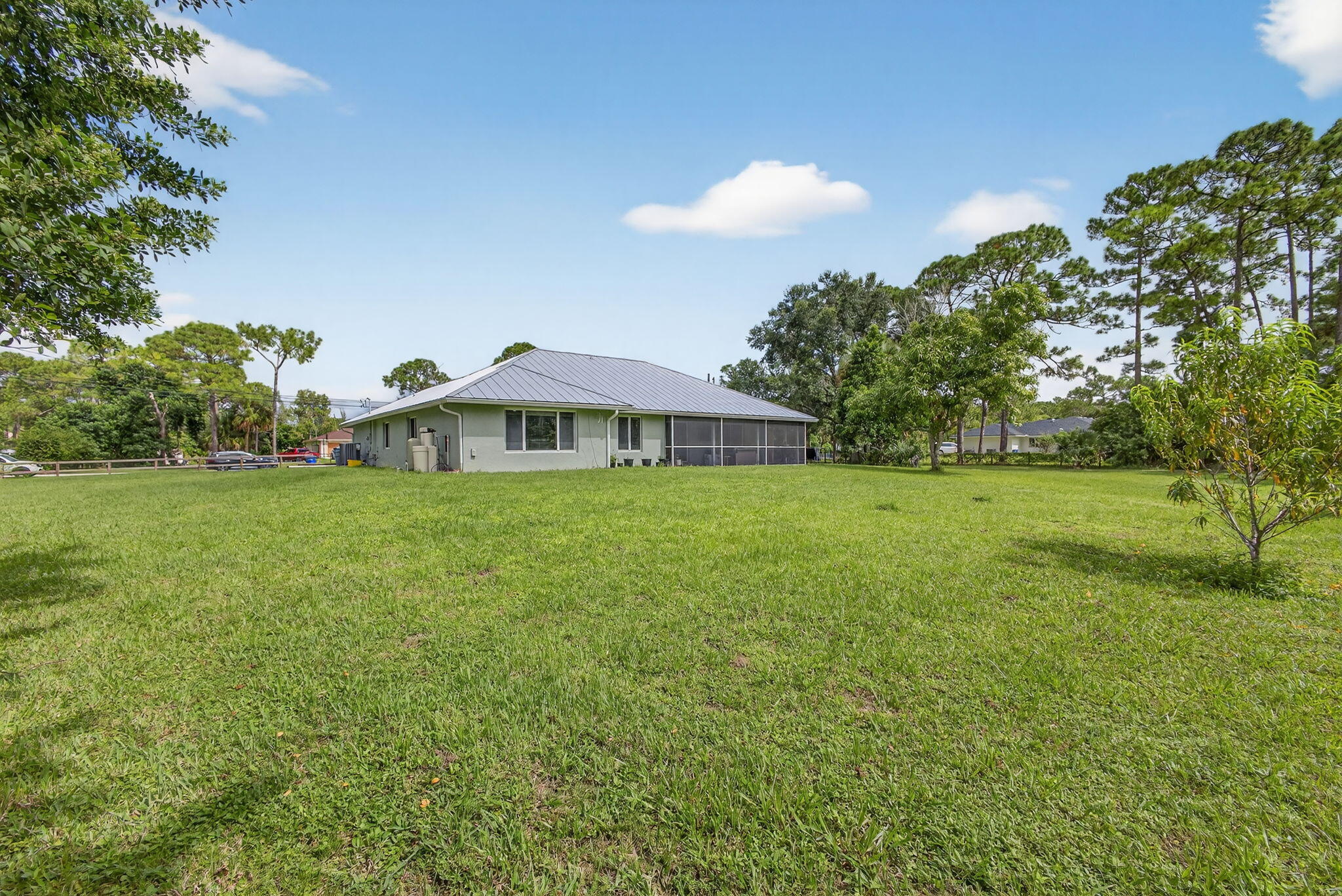 14366 76th Road North The Acreage, FL 33470 - Photo 65 of 76 a backyard of a house with lots of green space