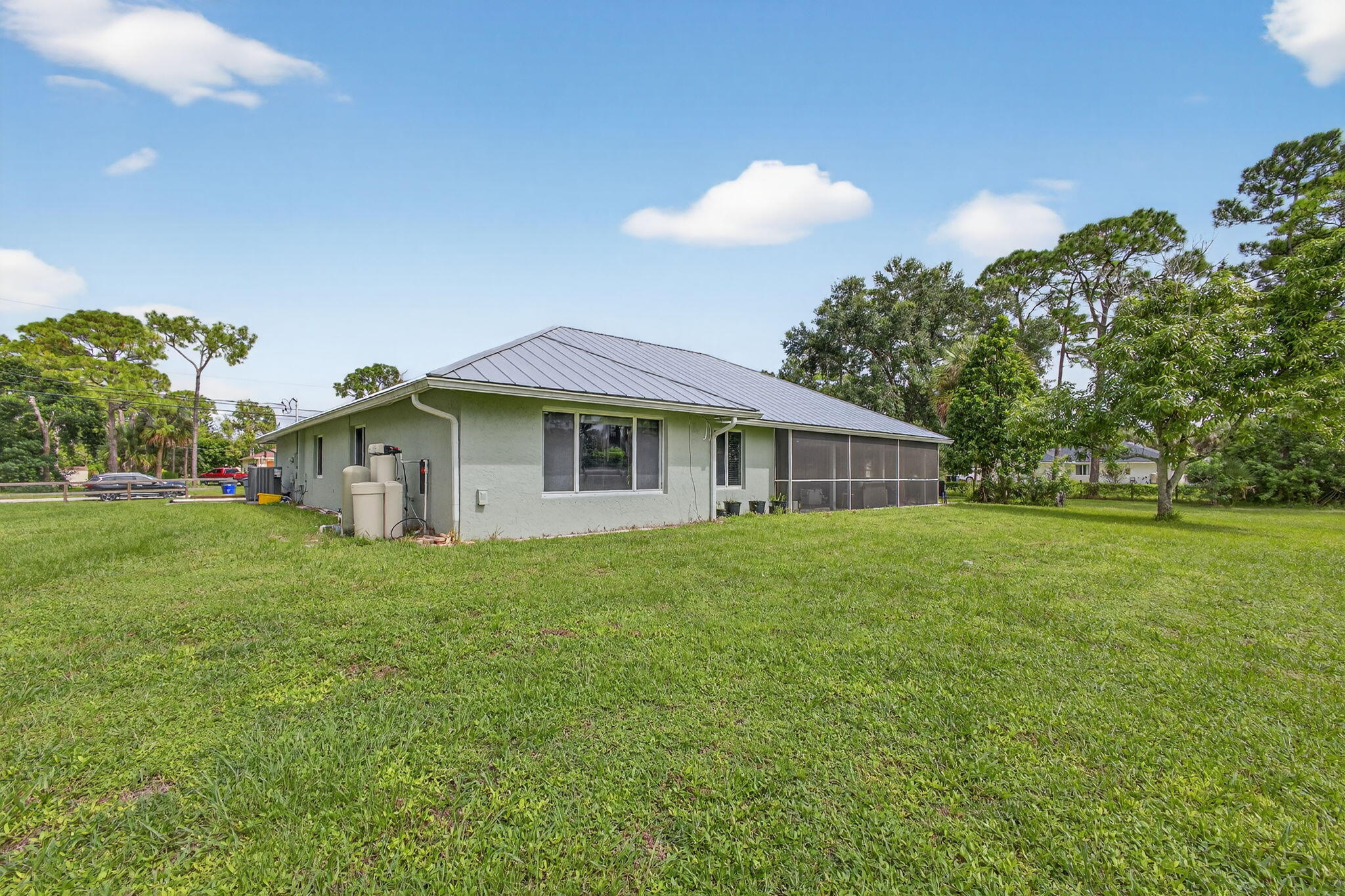 14366 76th Road North The Acreage, FL 33470 - Photo 66 of 76 a yellow and red house sitting in middle of the grass