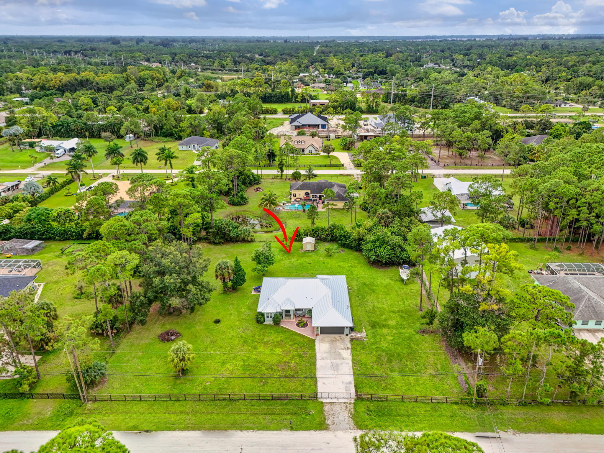 14366 76th Road North The Acreage, FL 33470 - Photo 69 of 76 an aerial view of residential houses with outdoor space and trees