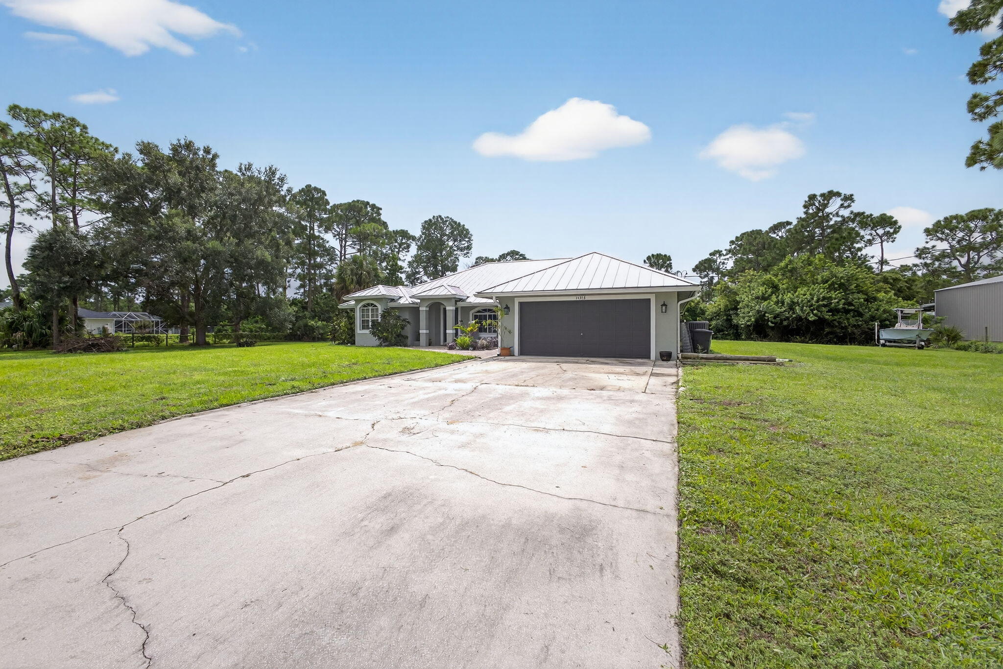 14366 76th Road North The Acreage, FL 33470 - Photo 7 of 76 a view of a house with a yard and garage