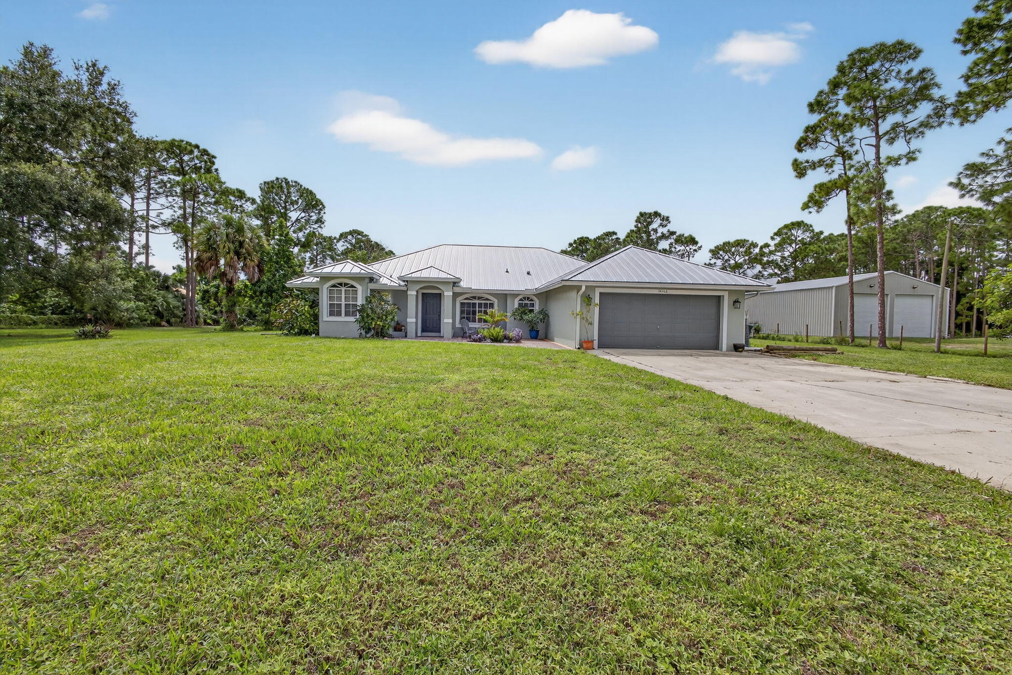 14366 76th Road North The Acreage, FL 33470 - Photo 8 of 76 a view of a house with a yard and sitting area