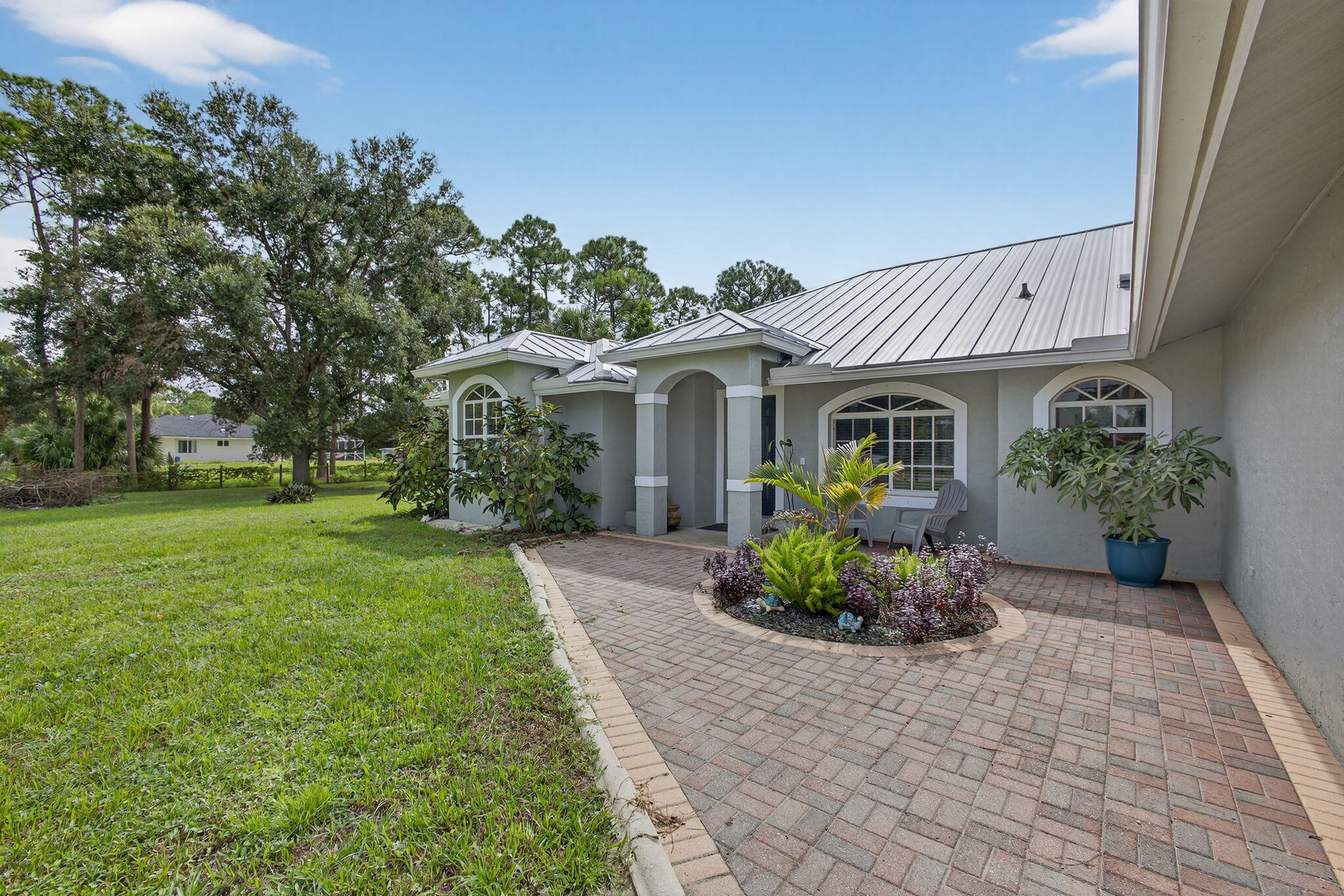 14366 76th Road North The Acreage, FL 33470 - Photo 10 of 76 a front view of a house with a garden