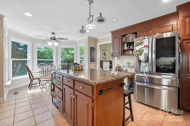 a kitchen with stainless steel appliances granite countertop a stove and a refrigerator