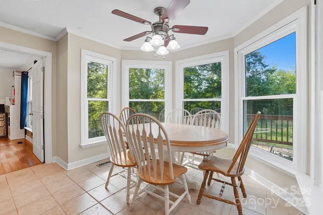 a dining room with furniture a chandelier and wooden floor