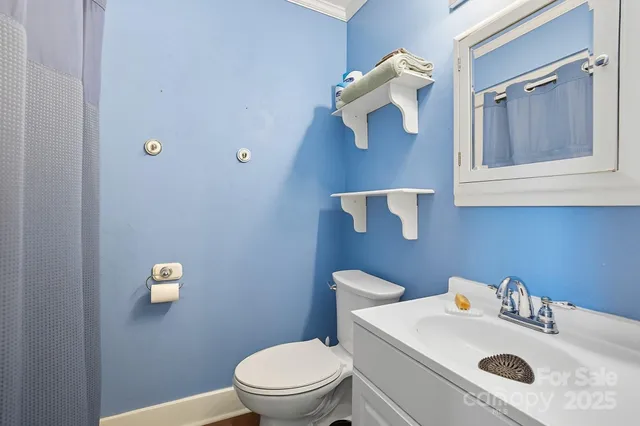 a bathroom with a sink vanity mirror and toilet