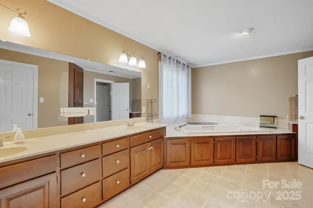 a spacious bathroom with a granite countertop sink and a mirror