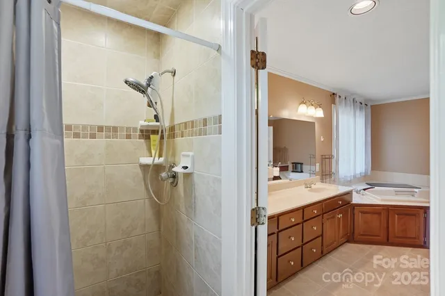 a spacious bathroom with a double vanity sink a mirror and a shower