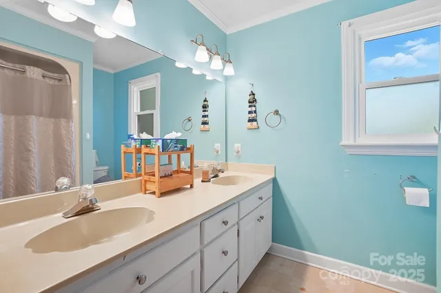 a bathroom with a sink double vanity granite and a mirror