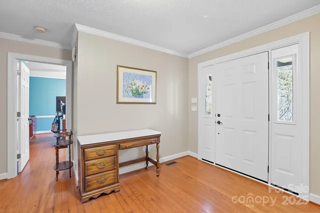 a view of a workspace with wooden floor and bedroom view