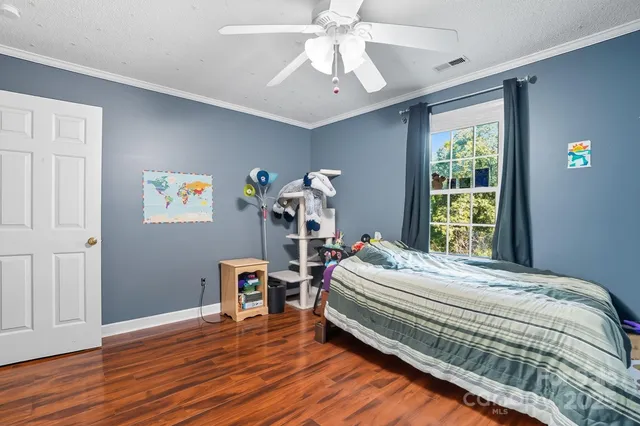 a bedroom with bed and a window