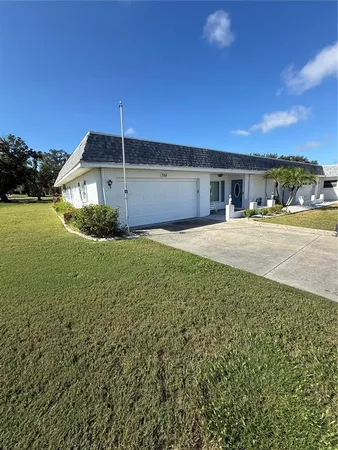 a view of a house with a yard and garage