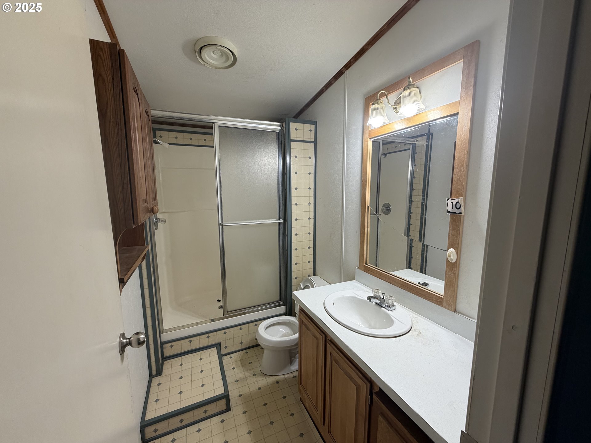 252 Northwest 20th Street Newport, OR 97365 - Photo 8 of 15 a bathroom with a sink a toilet a mirror and shower